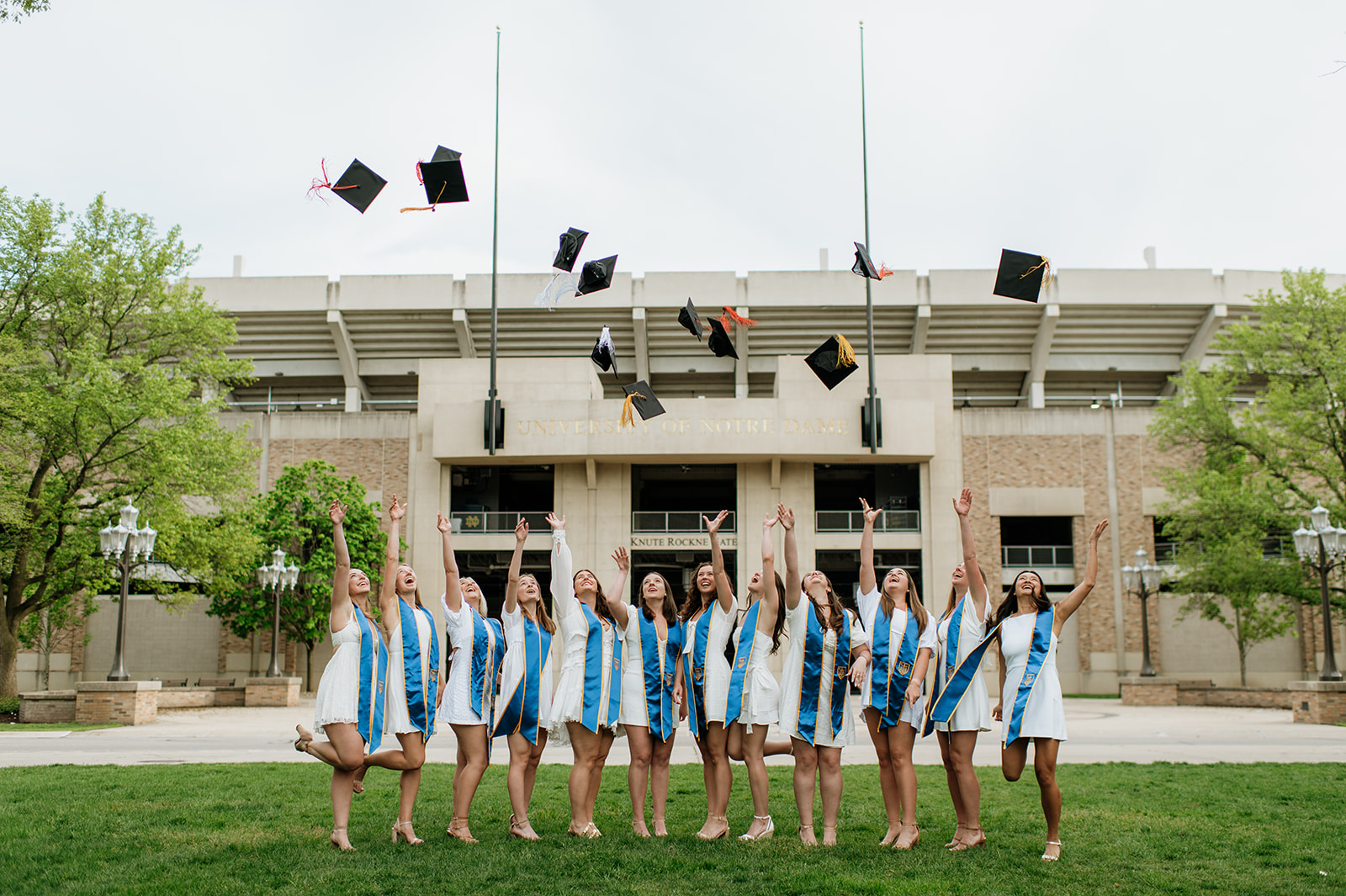 Girls throwing their caps in the air during their grad shoot