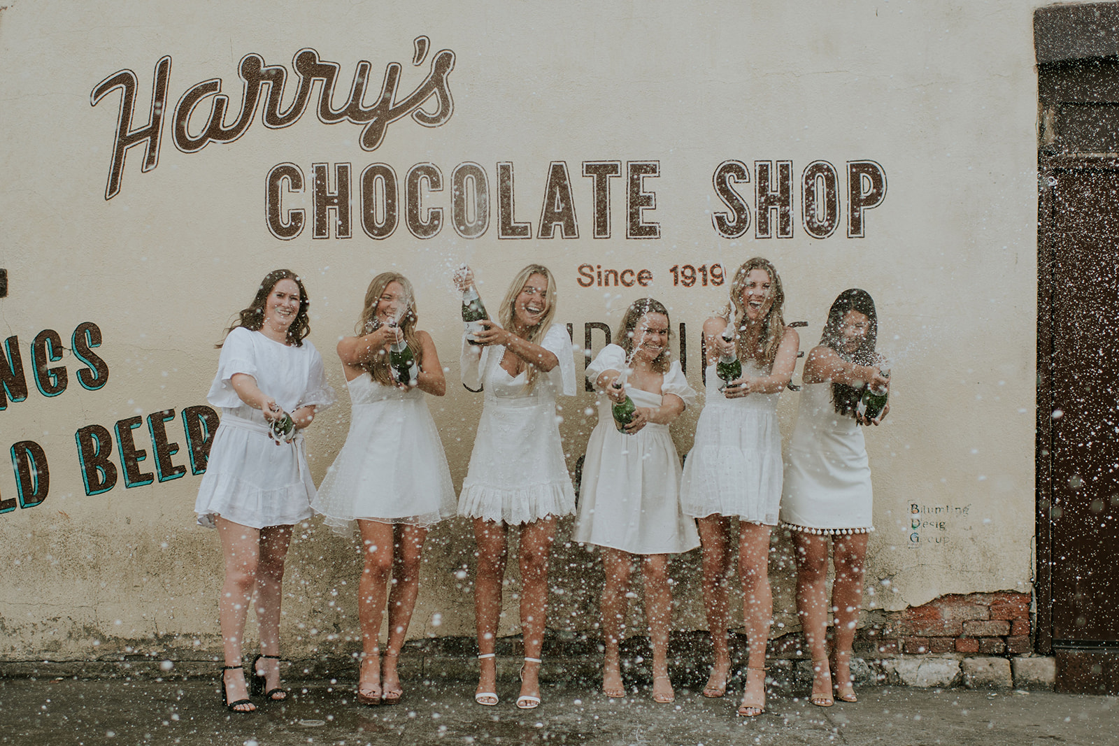 Girls popping champagne during their Northern Indiana graduation photos