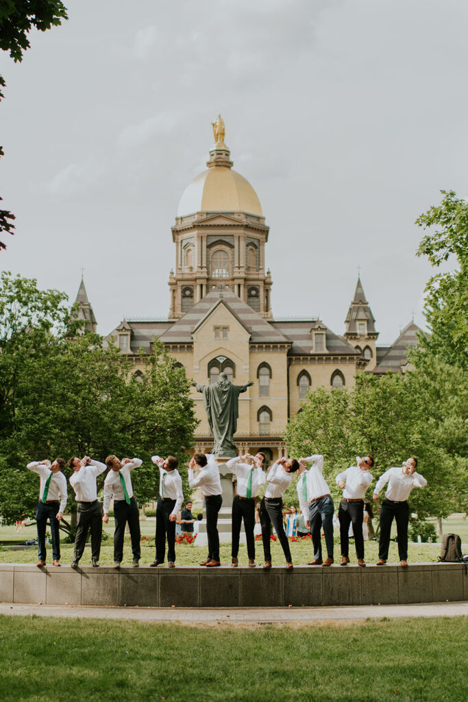 Men drinking beers during their group graduation photos