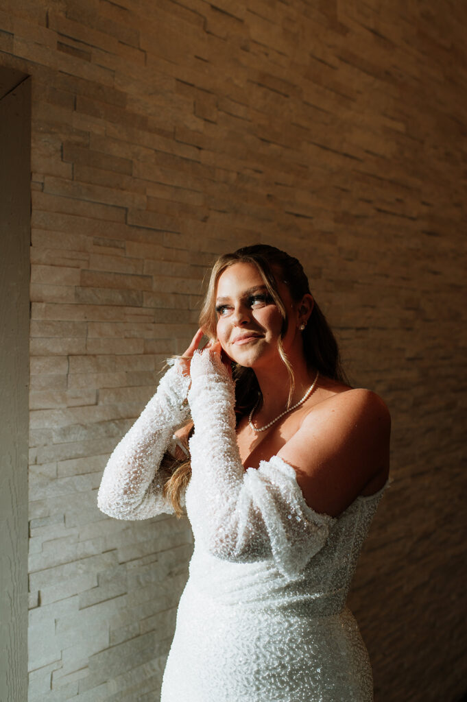 Bride putting her earrings in
