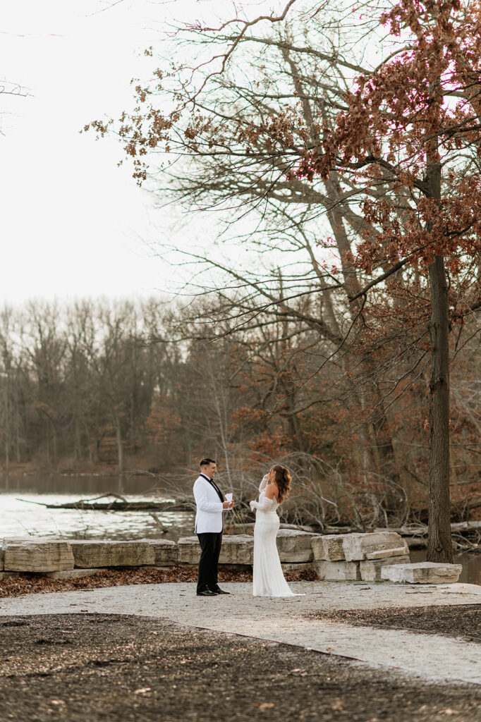 Bride and grooms exchanging vows during their winter wedding at The Allure on The Lake