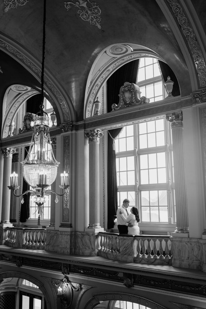 Black and white photo of a couple posing at Morris Performing Arts Center in South Bend, Indiana