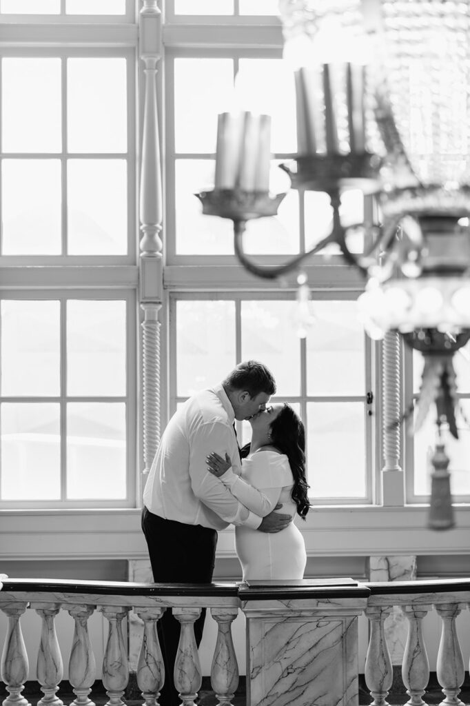 Black and white photo of a couple kissing at Morris Performing Arts Center in South Bend, Indiana