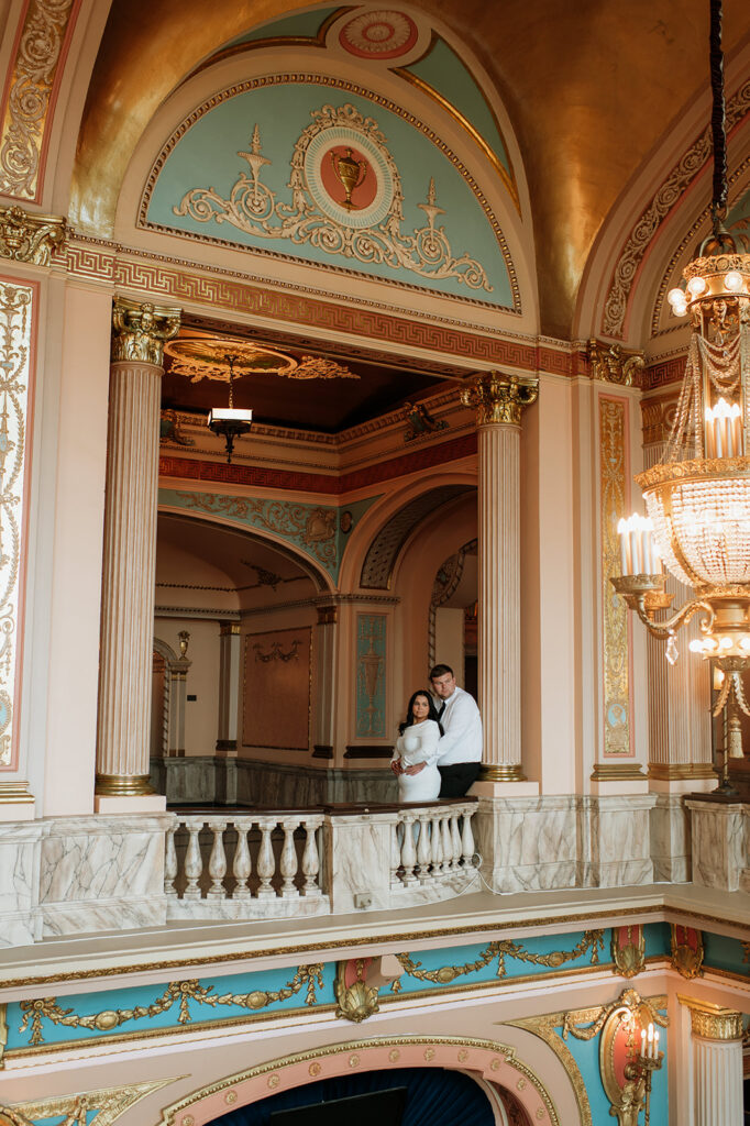 Couple posing for engagement photos at the Morris Performing Arts Center