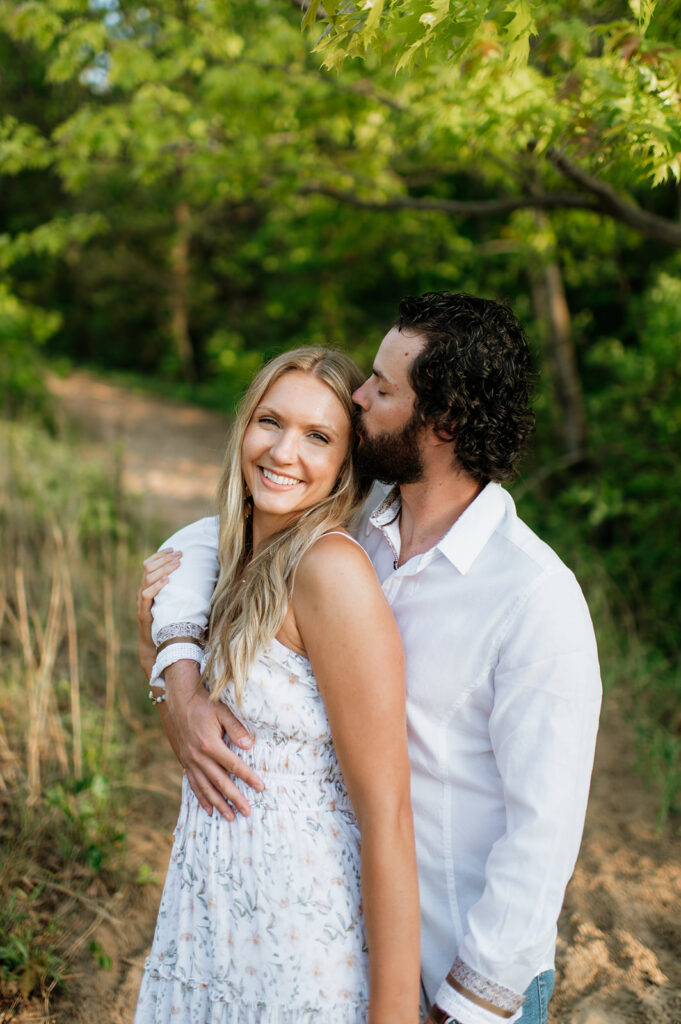 
Couple posing along a beach trail for their summer engagement photos in Indiana

