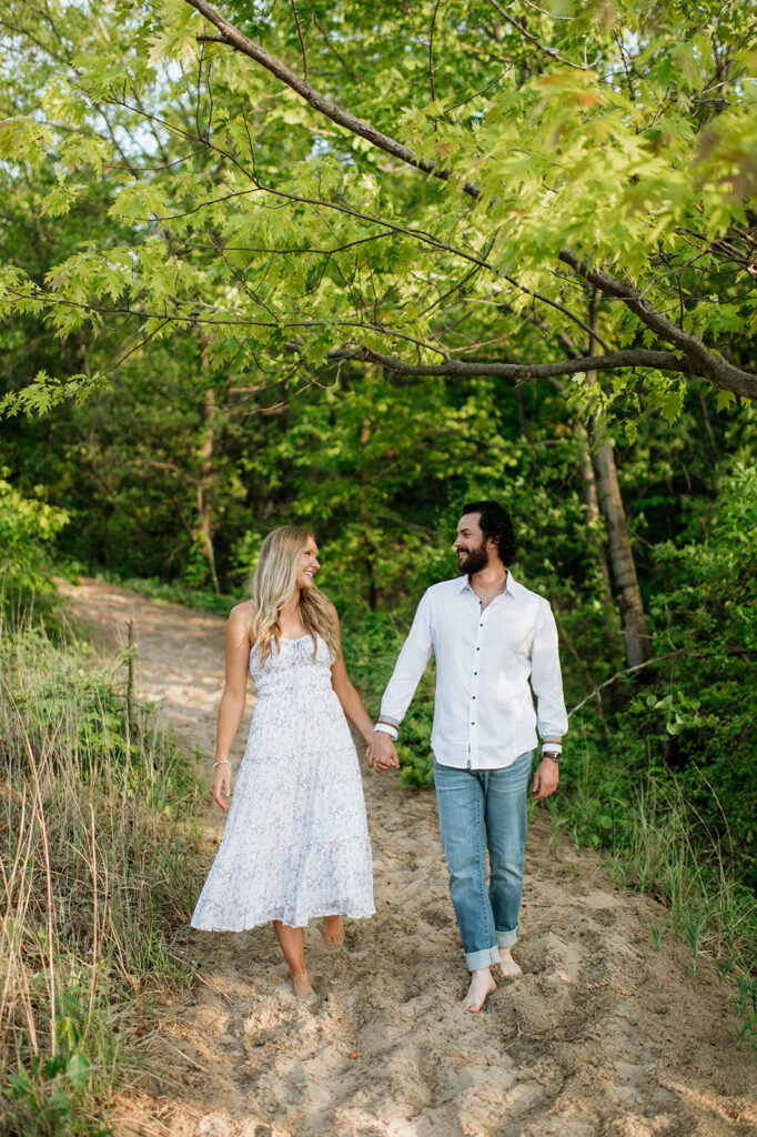 
Couple posing along a beach trail for their summer engagement photos in Indiana
