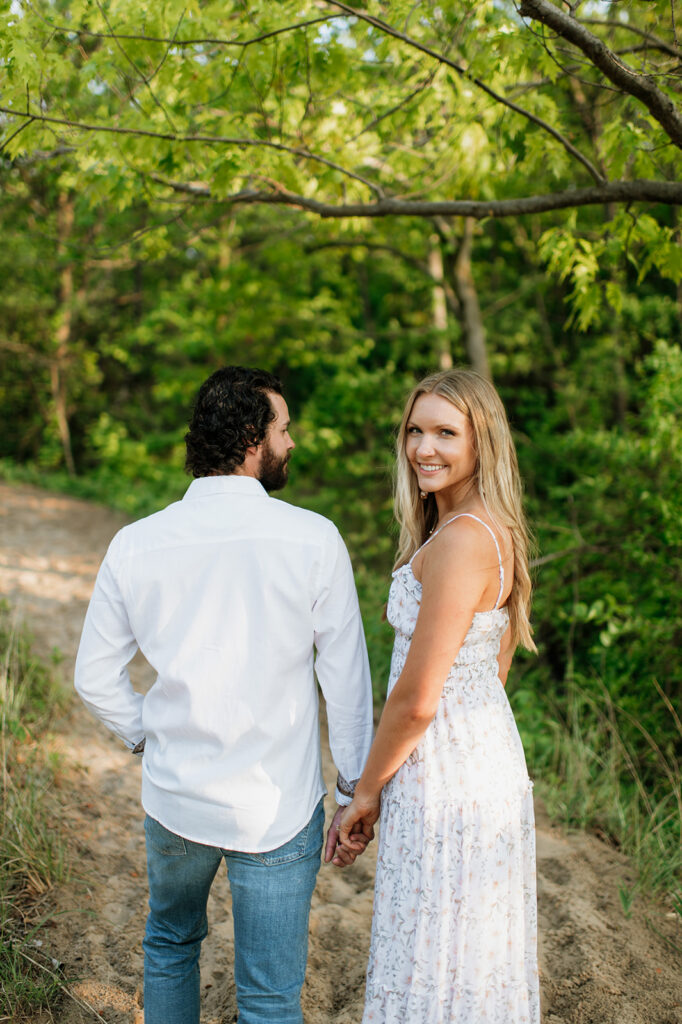 
Couple posing along a beach trail for their summer engagement photos in Indiana
