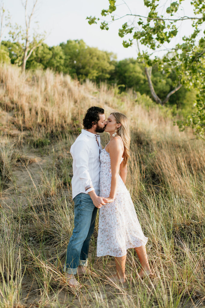 Couple kissing in the beach grass