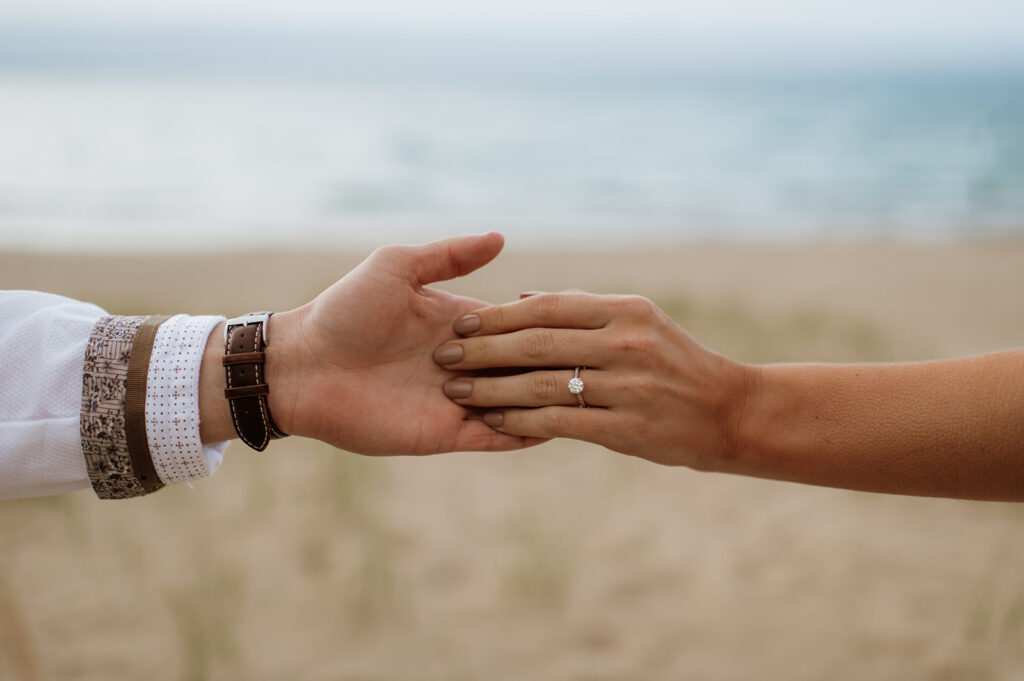 Couple holding hands on the beach