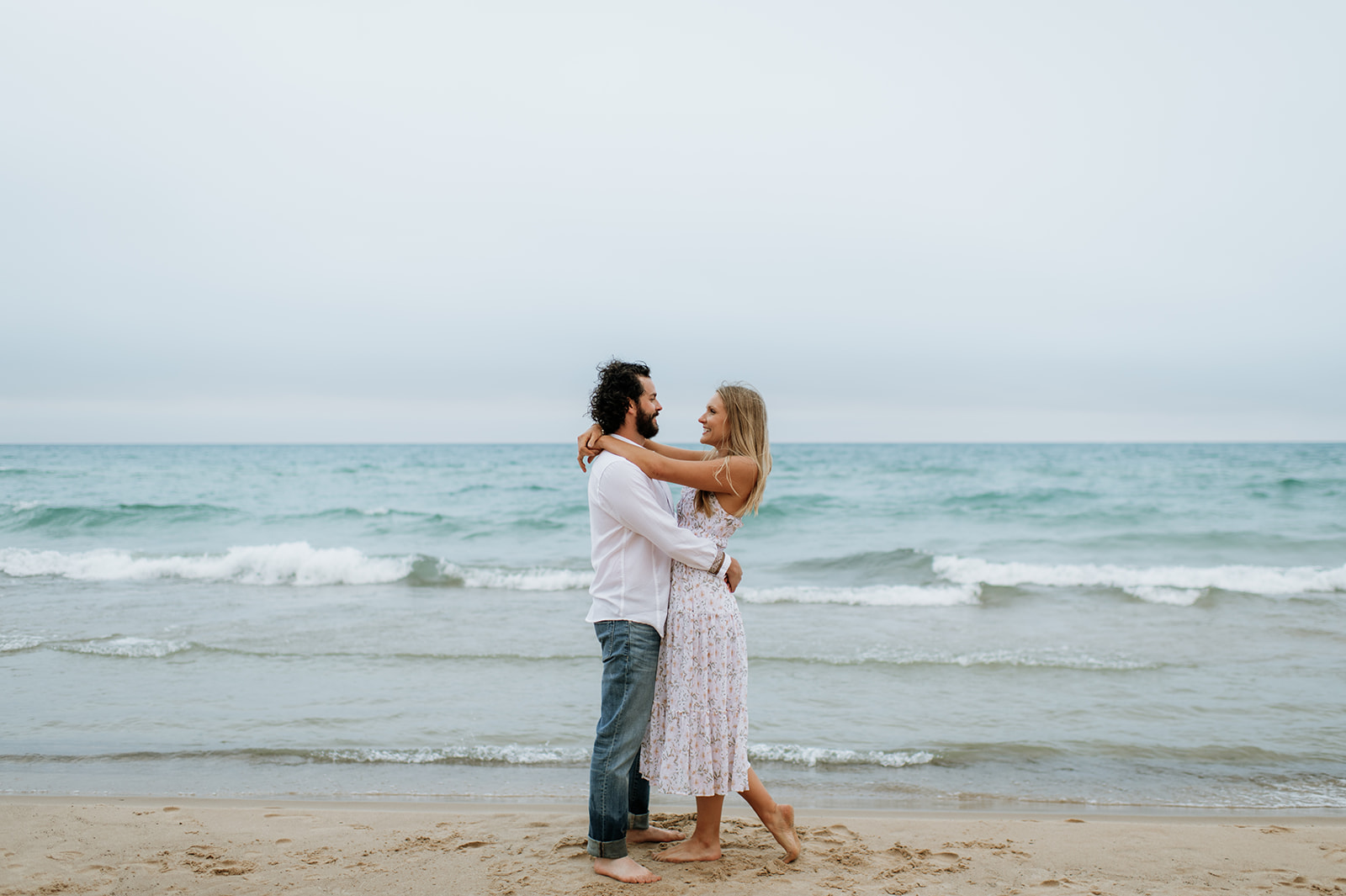 Couple posing at Indiana Dunes National Park for their beach engagement photos