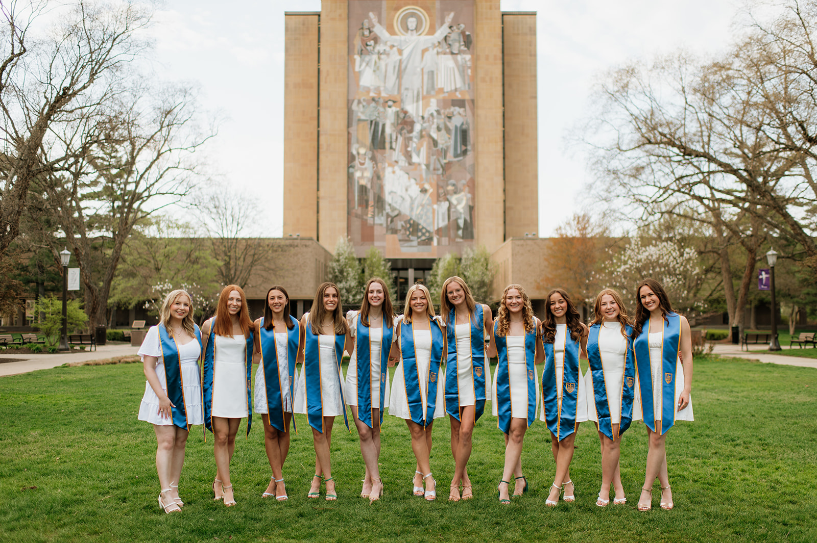 11 University of Notre Dame grads posing in front of Touchdown Jesus