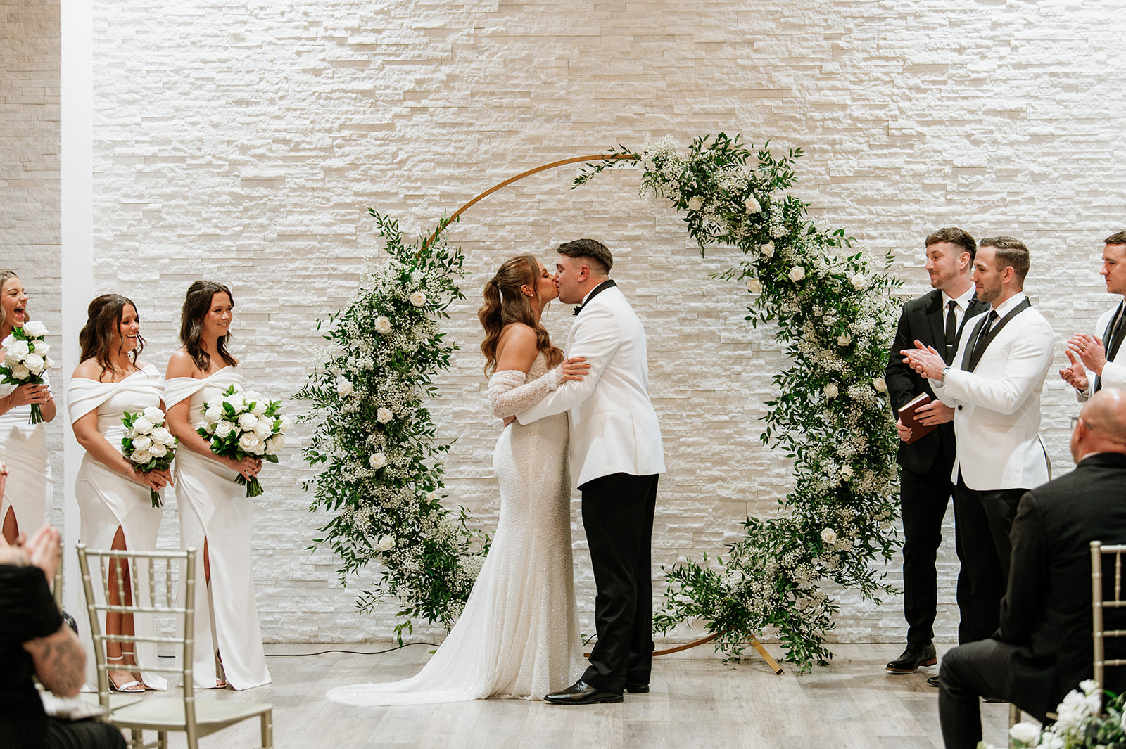 Bride and groom kissing during their wedding ceremony