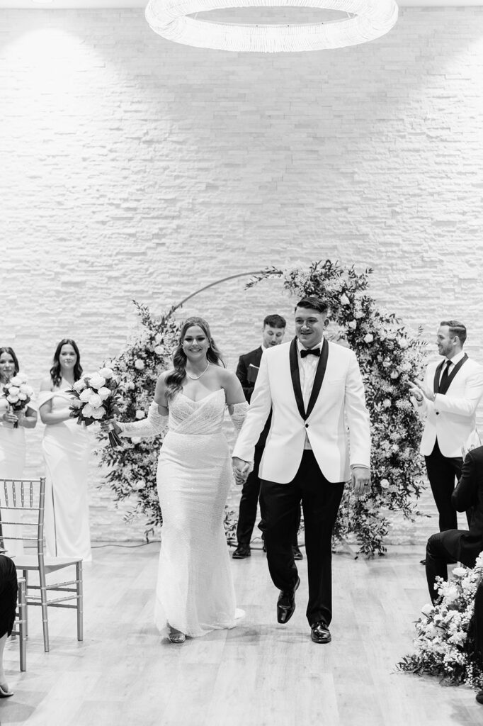 Bride and groom walking back down the aisle as husband and wife