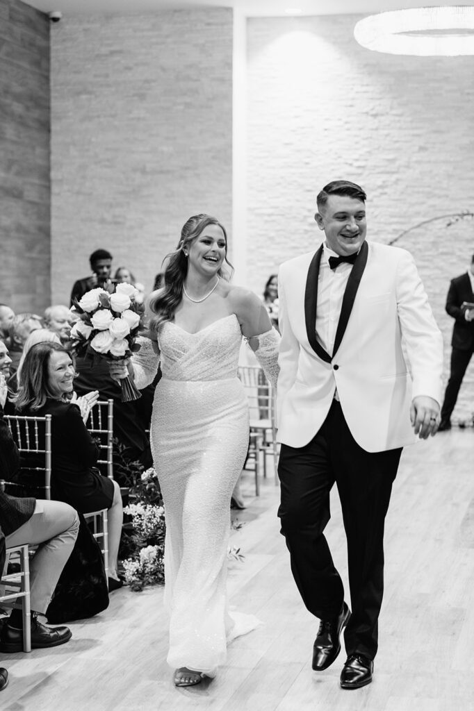 Bride and groom walking back down the aisle as husband and wife