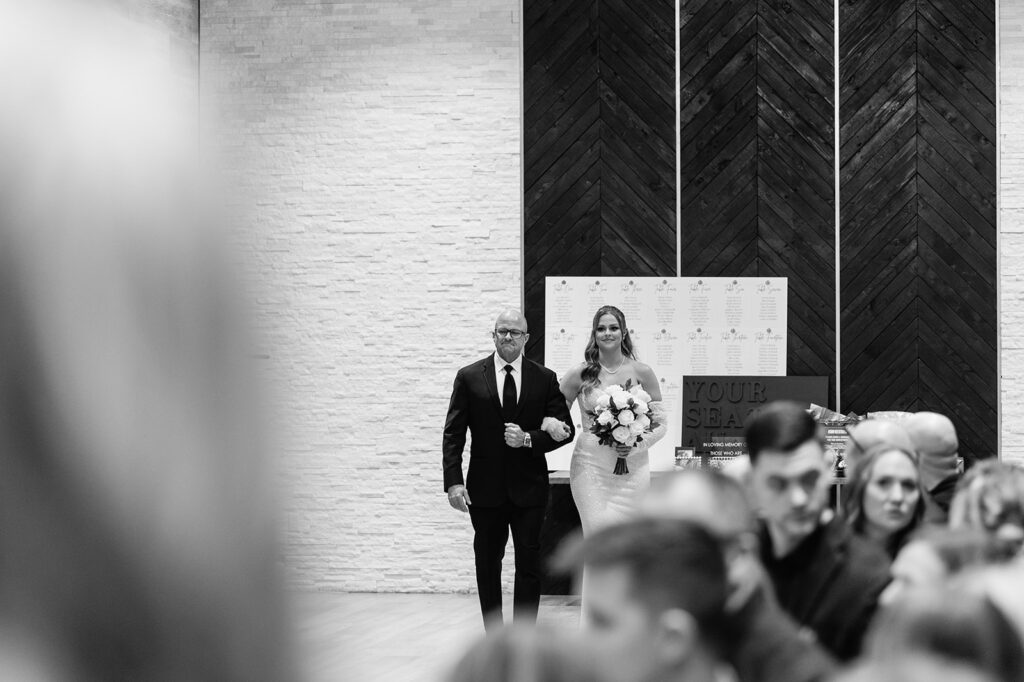 Bride being walked down the aisle by her father