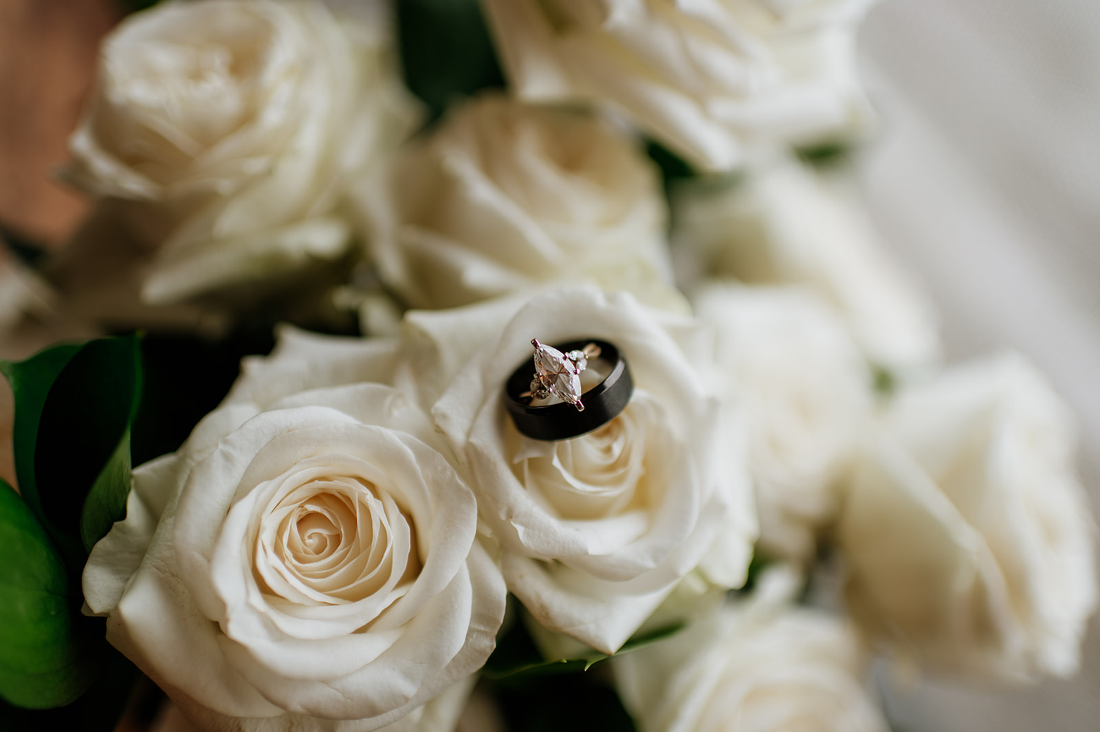 Winter wedding details with wedding ring and band in bouquet