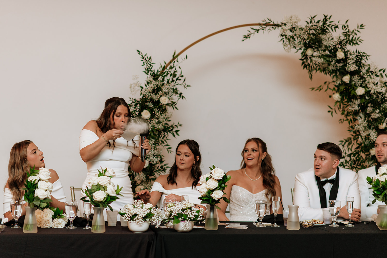 Maid of honor giving a speech and blowing off :dust" from her speech