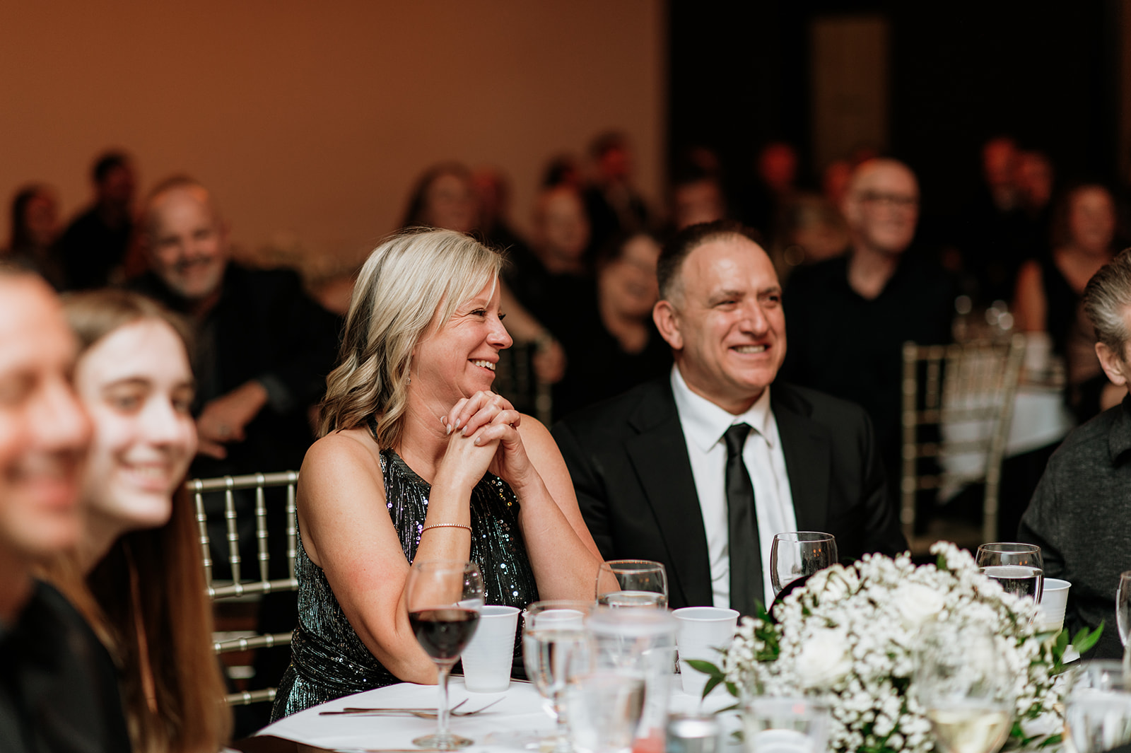 Mother of the groom smiling during reception speeches