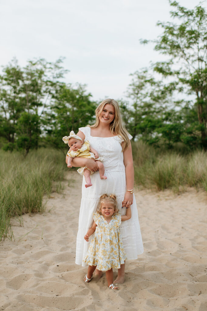 Aunt posing with her two nieces on the beach