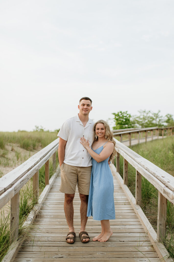 Couple posing on a boardwalk at New Buffalo Beach in Michigan