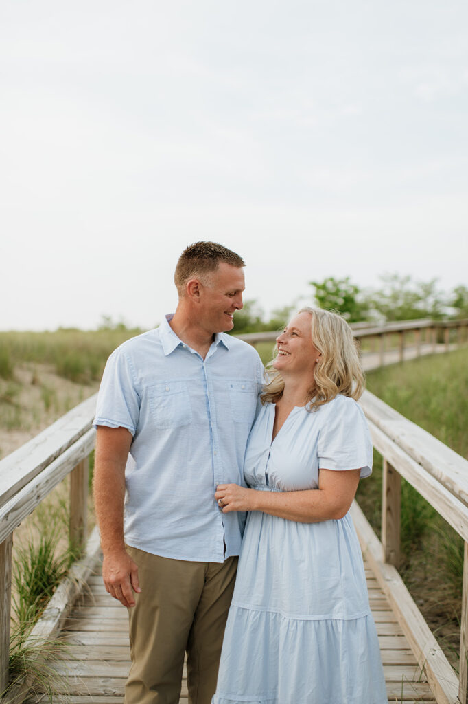 Couple posing on a boardwalk at New Buffalo Beach in Michigan