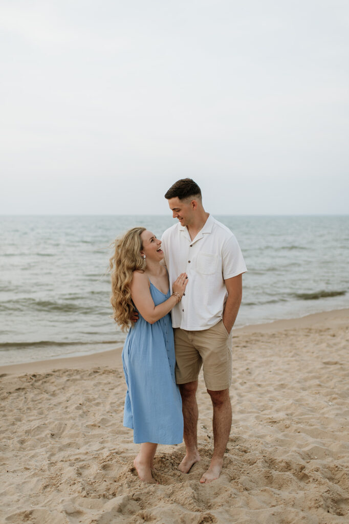 Couple laughing on the Lake Michigan shoreline of New Buffalo Beach