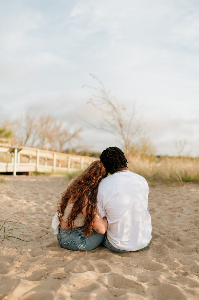 Couple cuddling up together on the beach