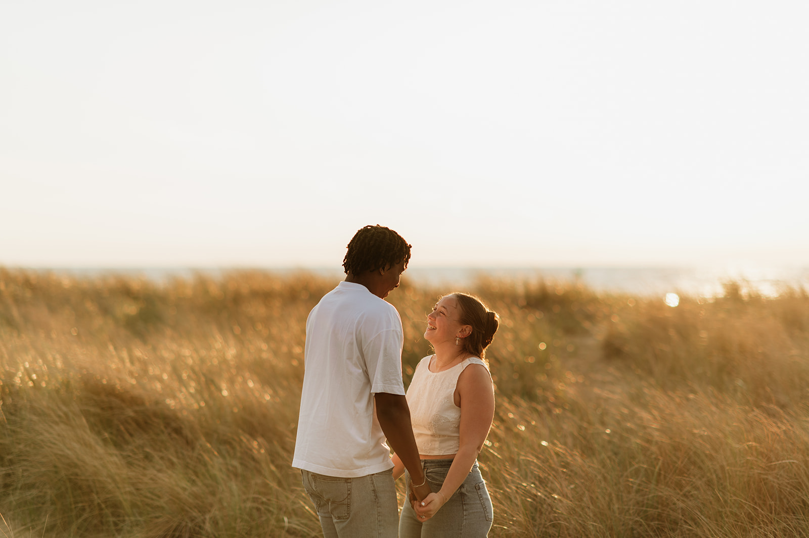 Couple holding hands during their sunset engagement session