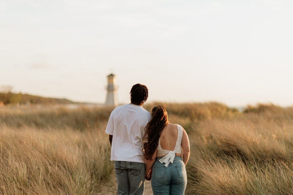 Couple admiring the lighthouse at New Buffalo Beach