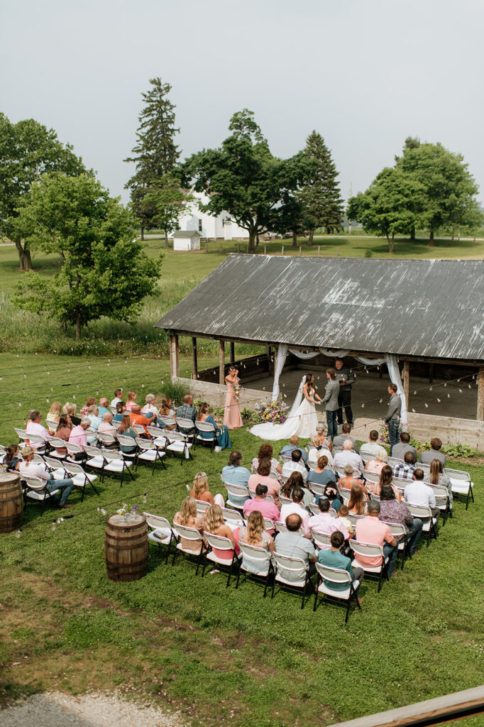An outdoor rustic wedding ceremony at 5C Farms in Albion, Indiana