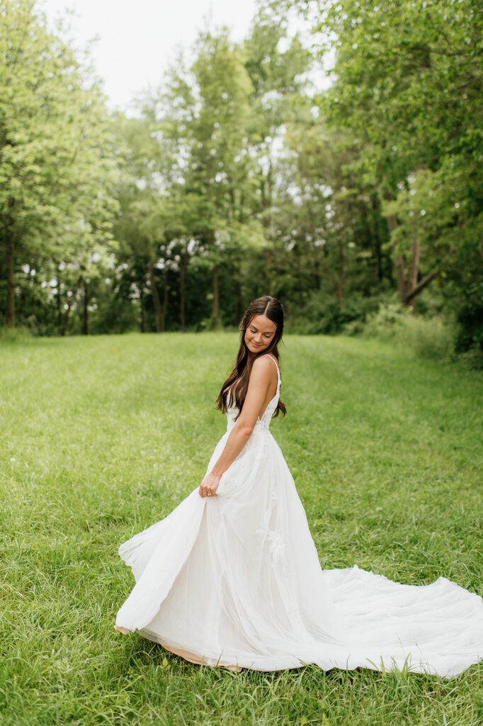 Outdoor portraits of a bride twirling in her wedding dress