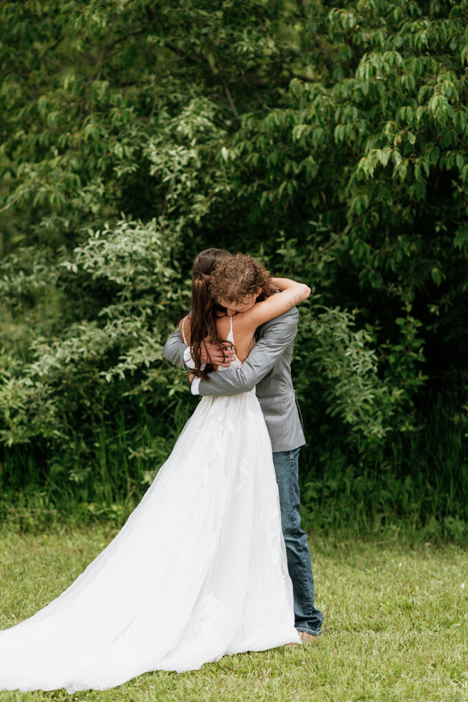 Bride and groom hugging after a first look outside