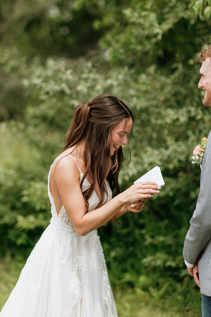 Bride and groom laughing during their private vow exchange