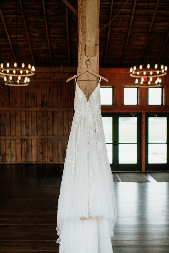 Brides wedding dress hanging off a beam at 5C wedding venue in Albion, Indiana
