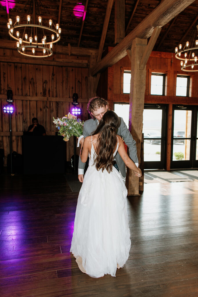 Bride and groom sharing a kiss after their reception entrance