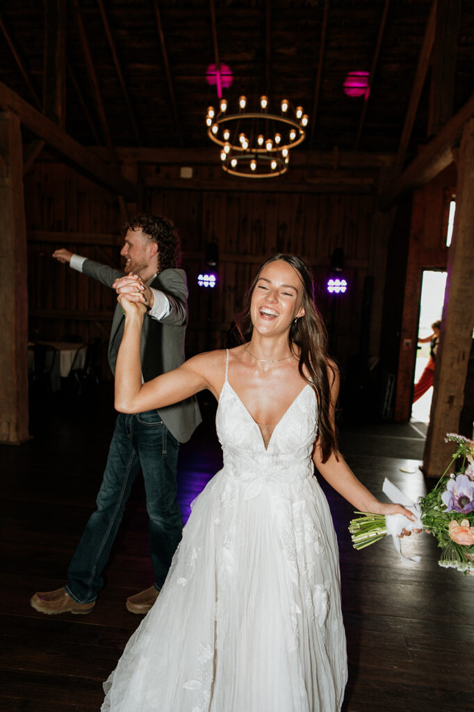 Bride and groom smiling as they enter their wedding reception