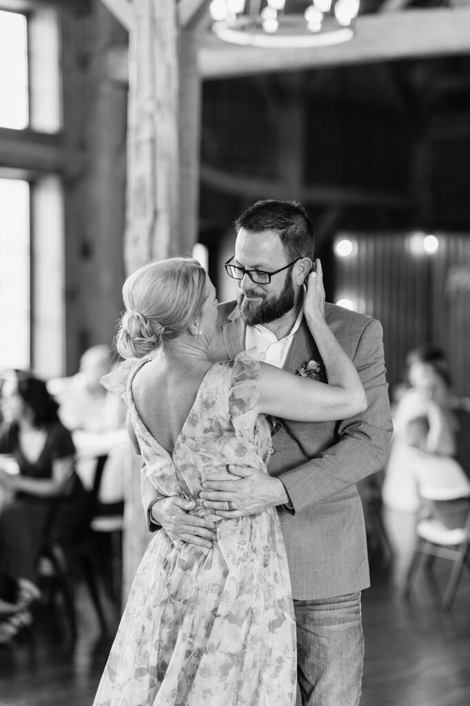 Black and white photo of the brides parents sharing an emotional dance