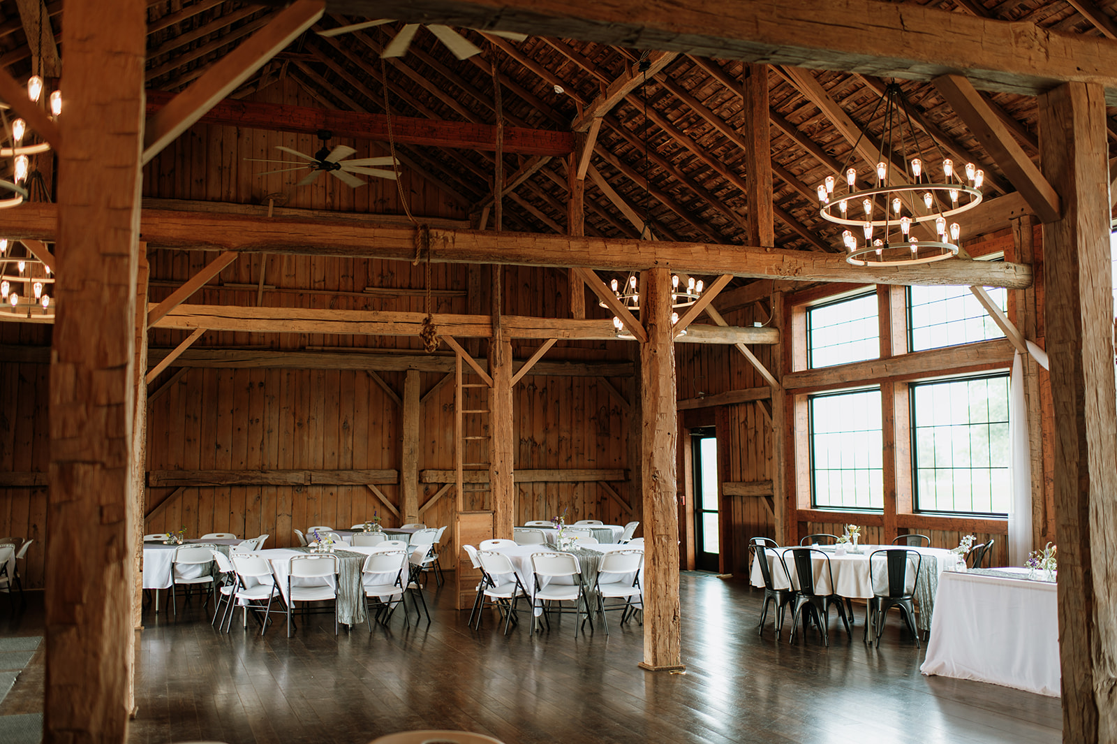 Wide shot of a 5C Farms wedding reception in the barn