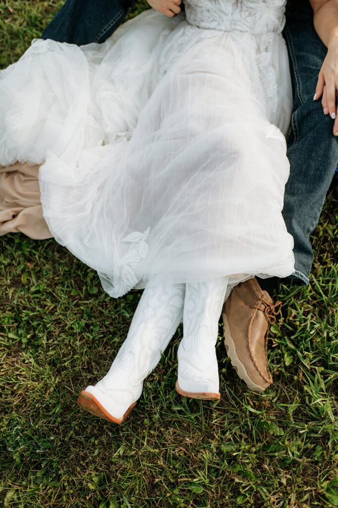 Bride and groom cuddling in the grass