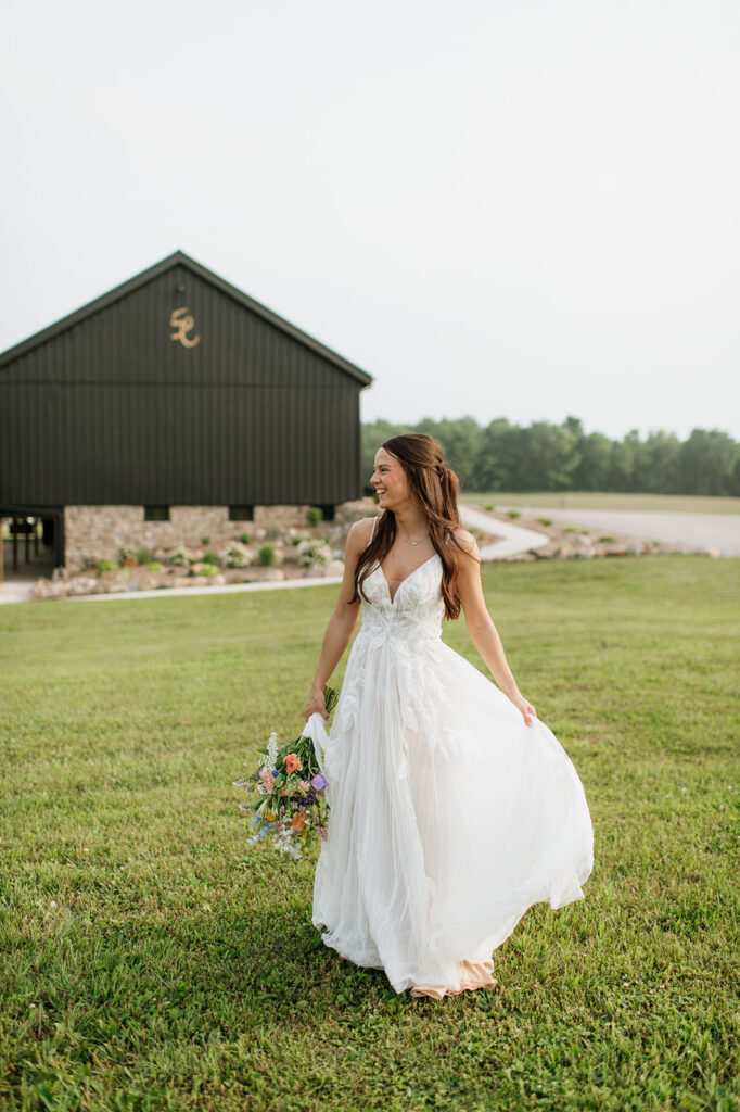 Bride posing outside of 5C Farms - - Premier Indiana barn wedding venue