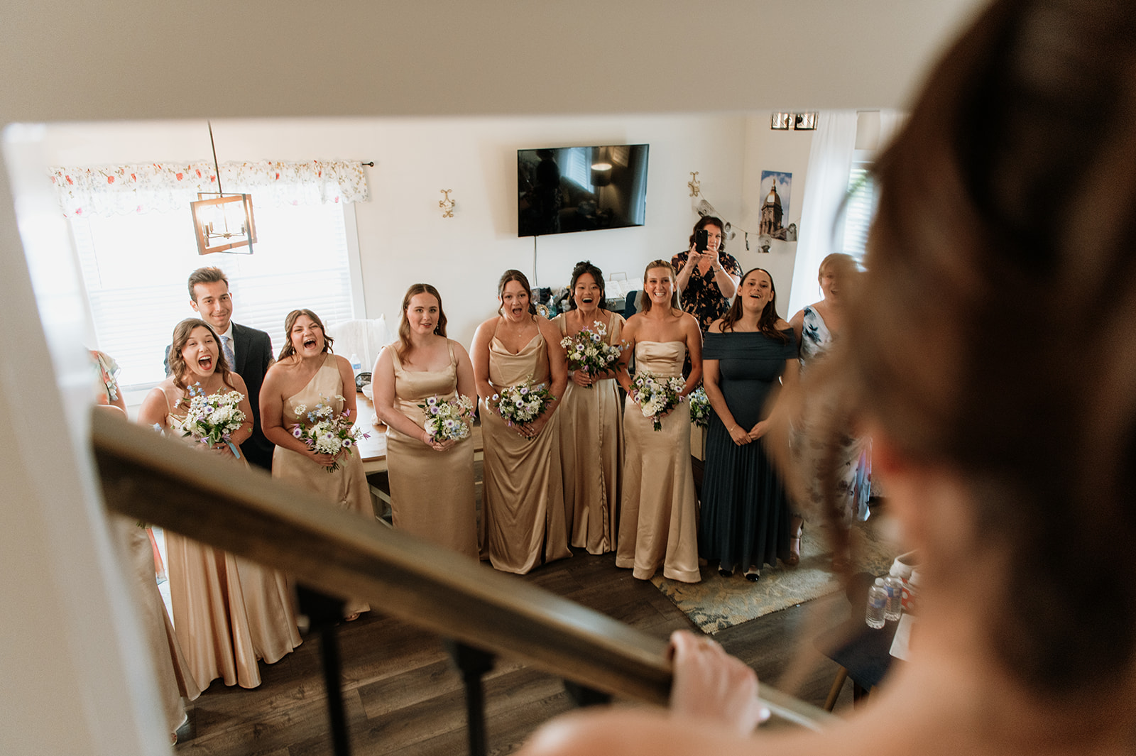 Bride sharing a first look with her bridesmaids after getting ready