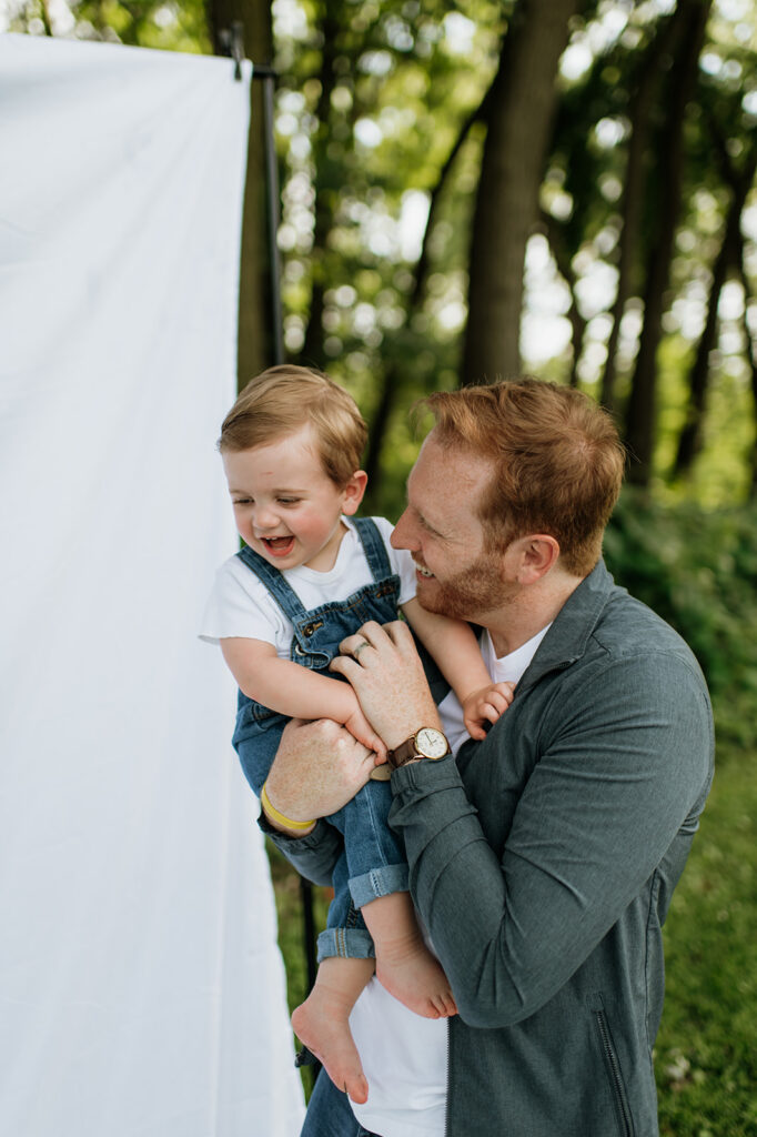 Dad holding his toddler son during their simple outdoor Chicago family photography session