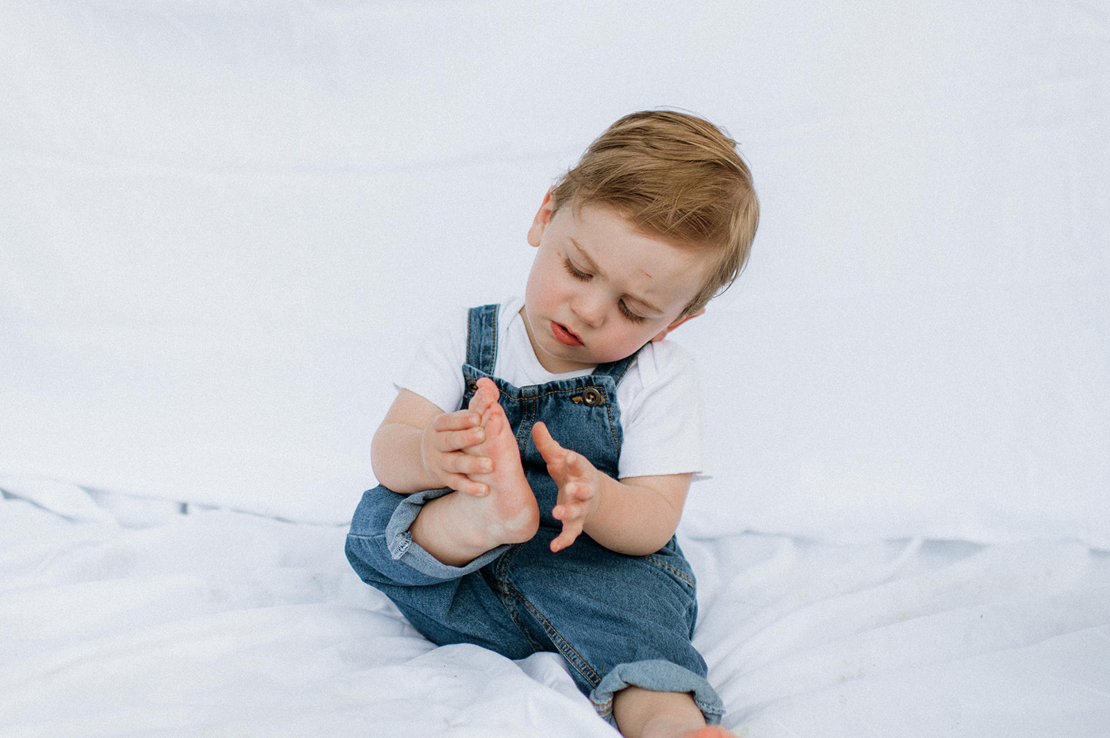 Little boy looking at his feet during a simple outdoor Chicago family photography session