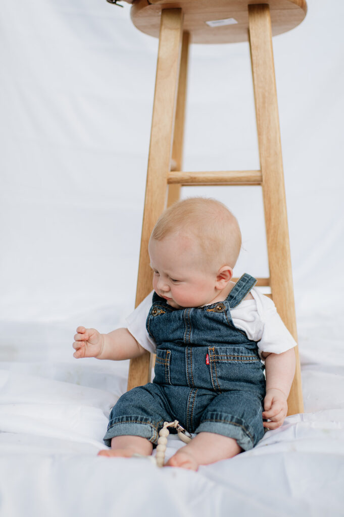 Baby sitting on a simple sheet backdrop for a casual Chicago family photography session