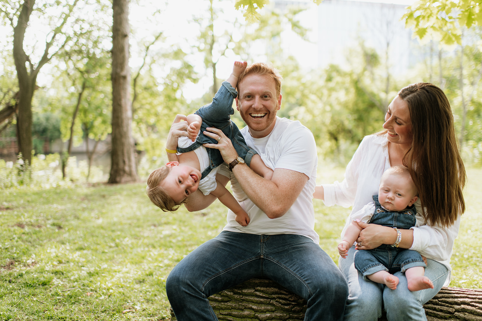 Dad holding his toddler up in the air during their simple outdoor Chicago family photography session