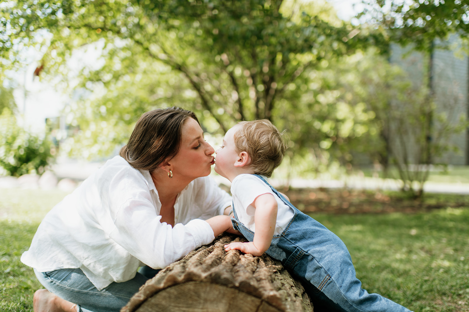 Mother kissing her toddler during their simple outdoor Chicago family photography session