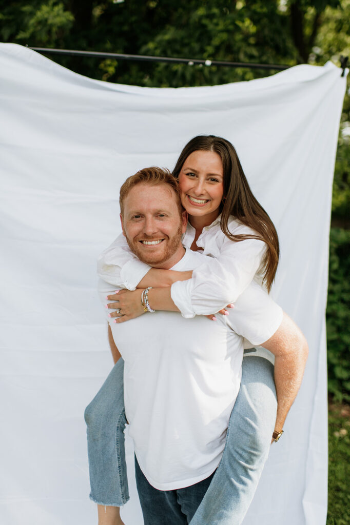 Woman getting a piggyback ride from her husband during their simple outdoor Chicago family photography session