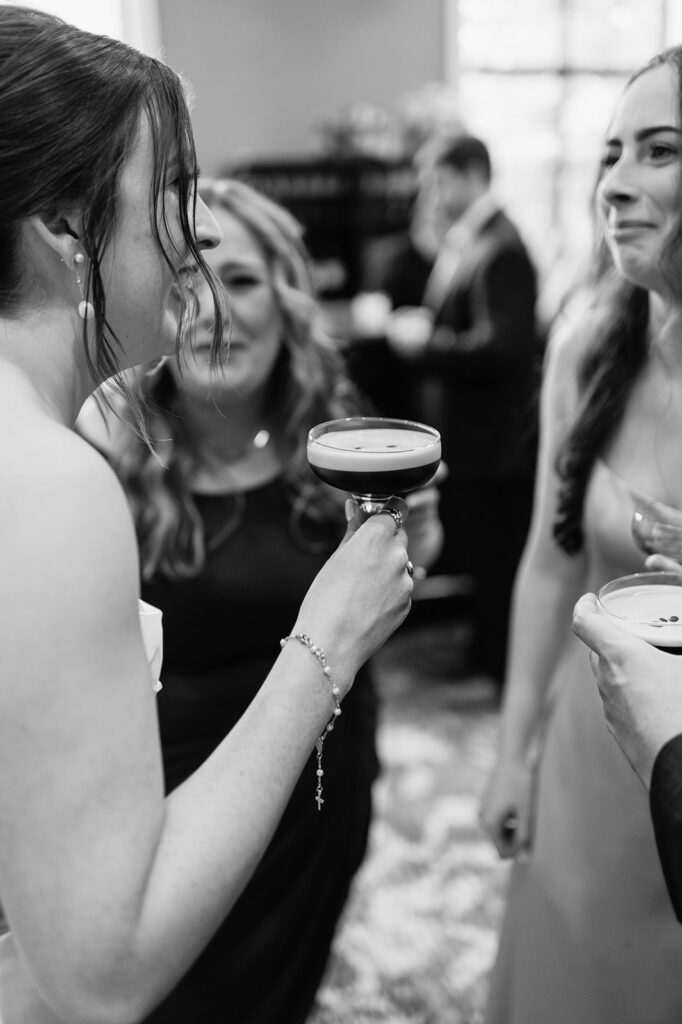 Black and white photo of bride mingling during cocktail hour