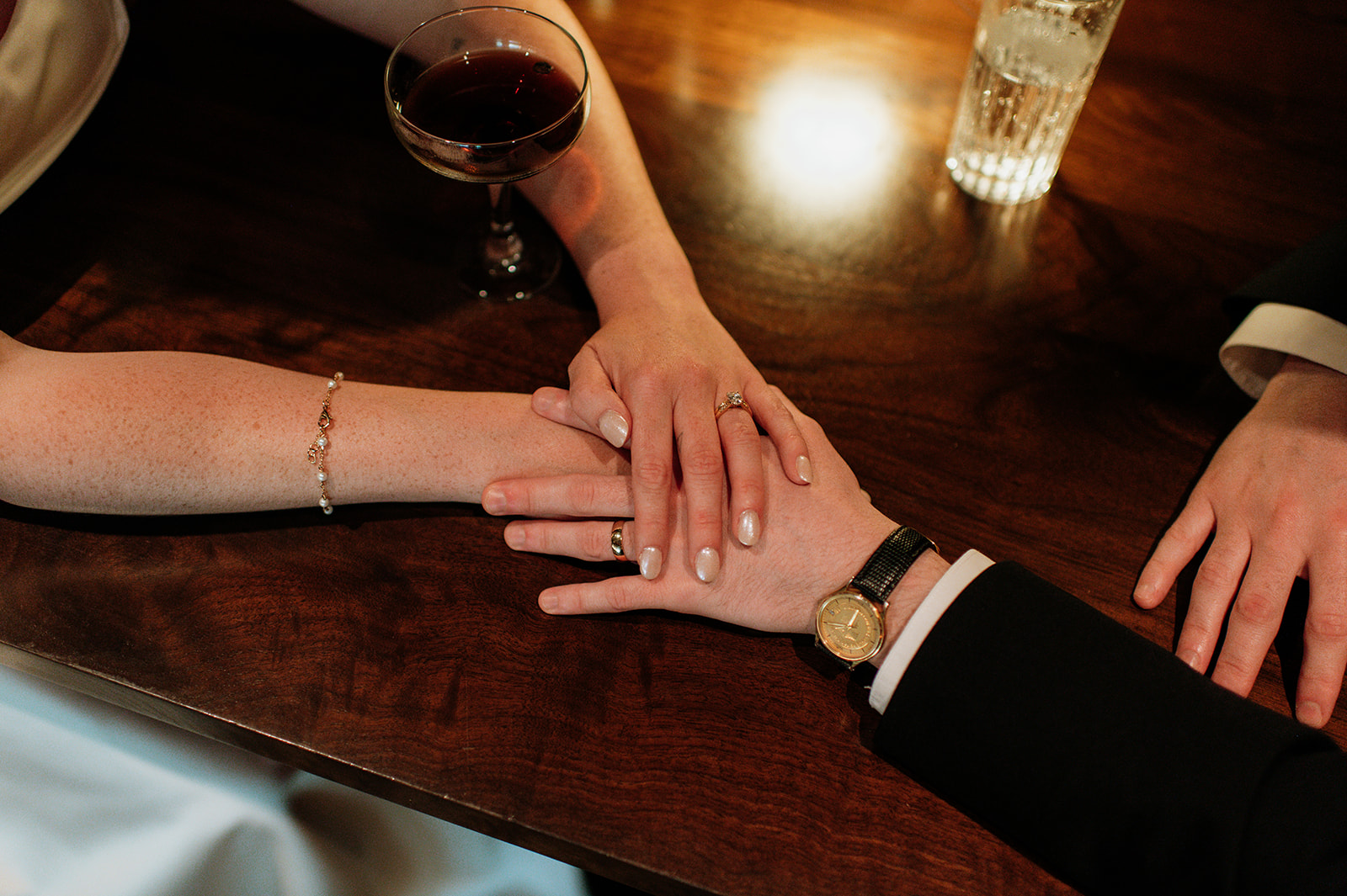 The couple shares a celebratory drink at Rohr’s restaurant inside the Morris Inn, seated at the table where they had their first date.