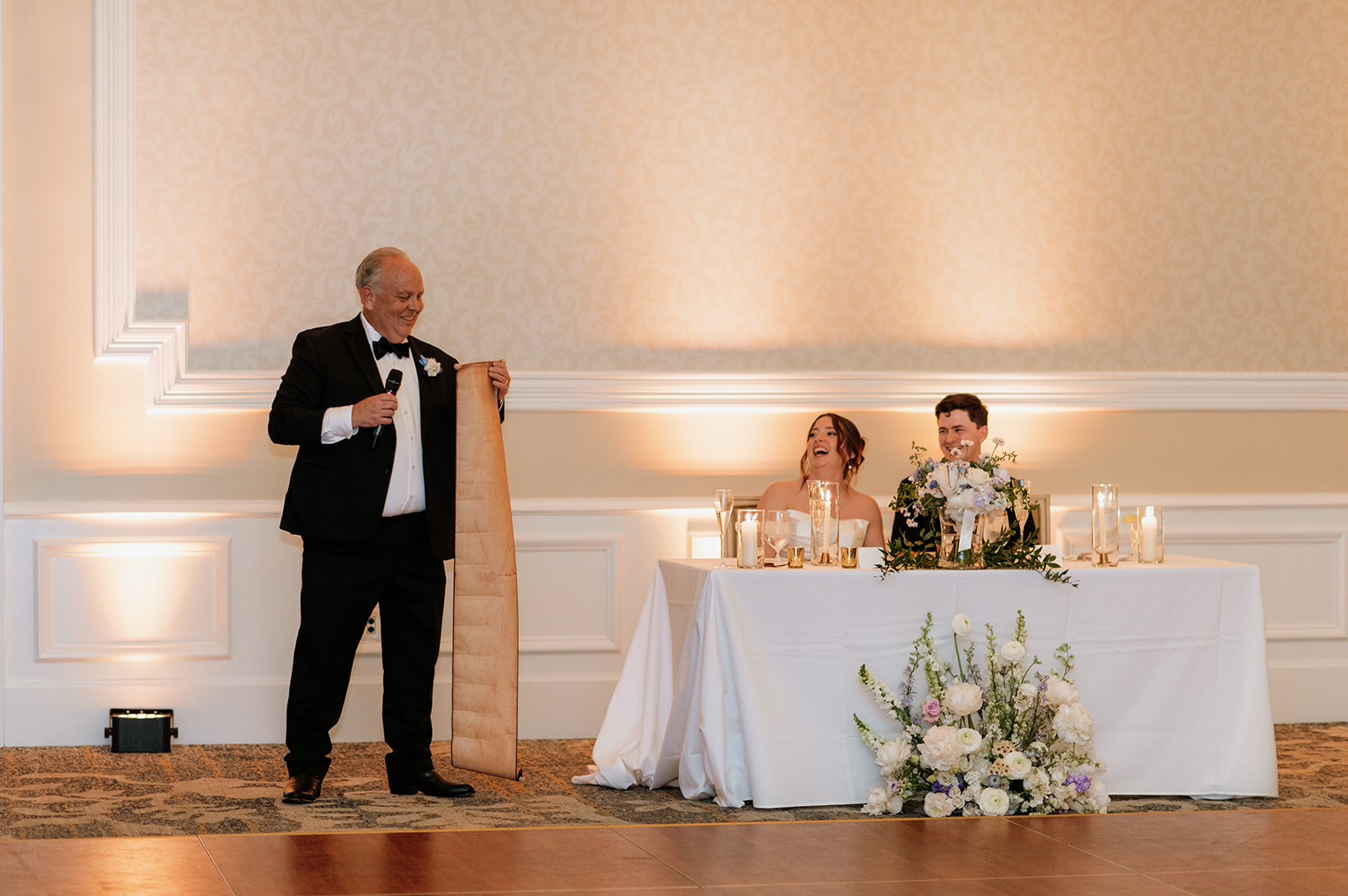 Father of the bride giving a speech with a long paper